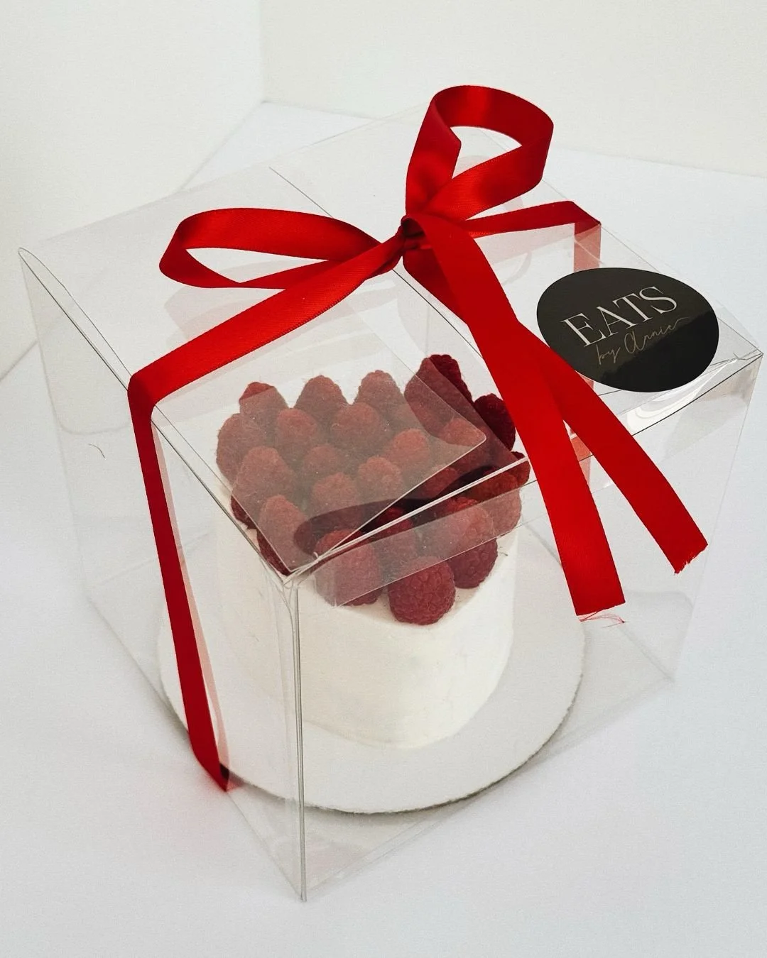 raspberry heart cake in box with red bow for valentine's day
