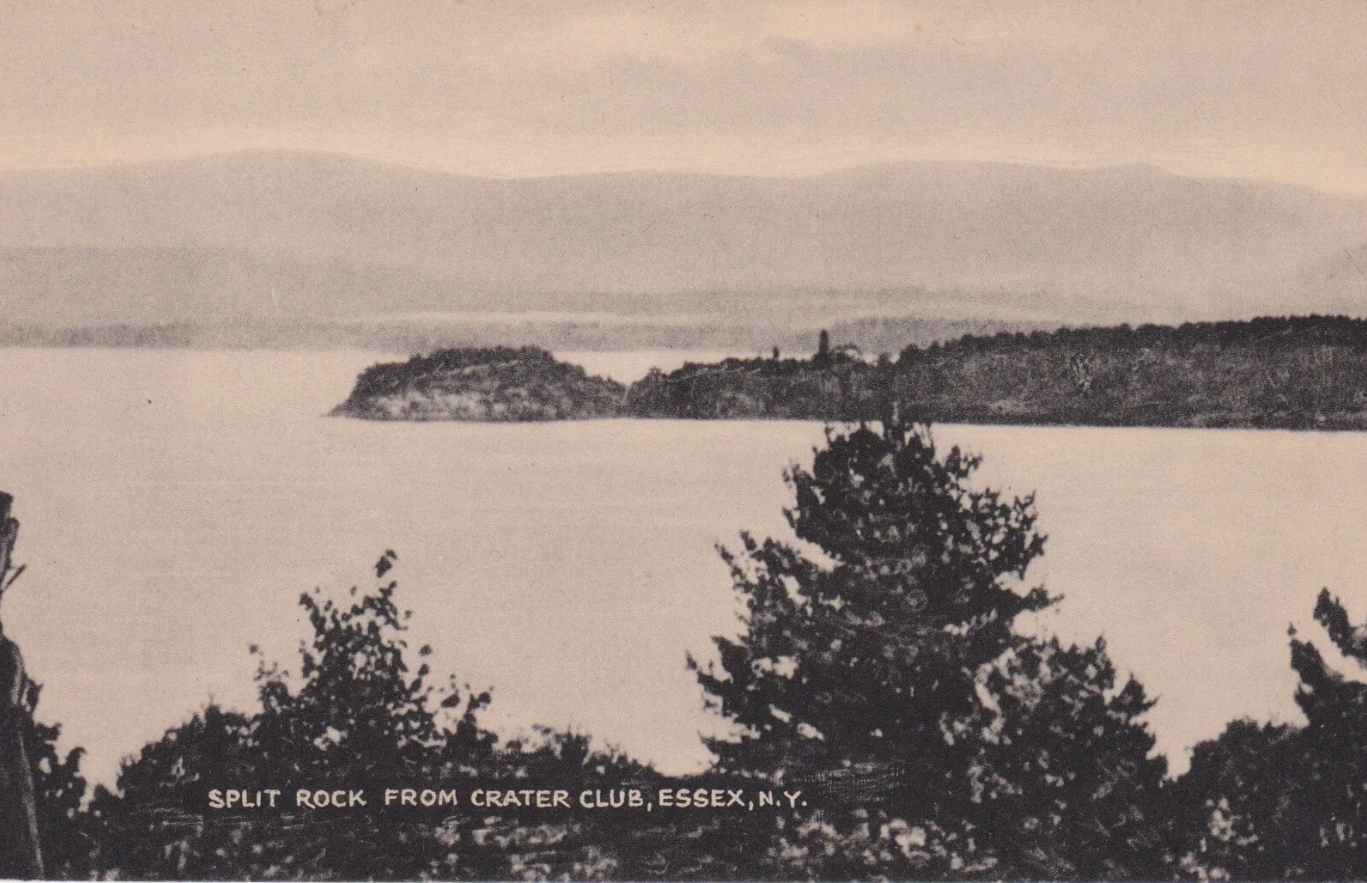 A black and white photograph of a body of water with an island in the background and trees in the foreground. The caption reads: "Split Rock from Crater Club, Essex, N.Y.".