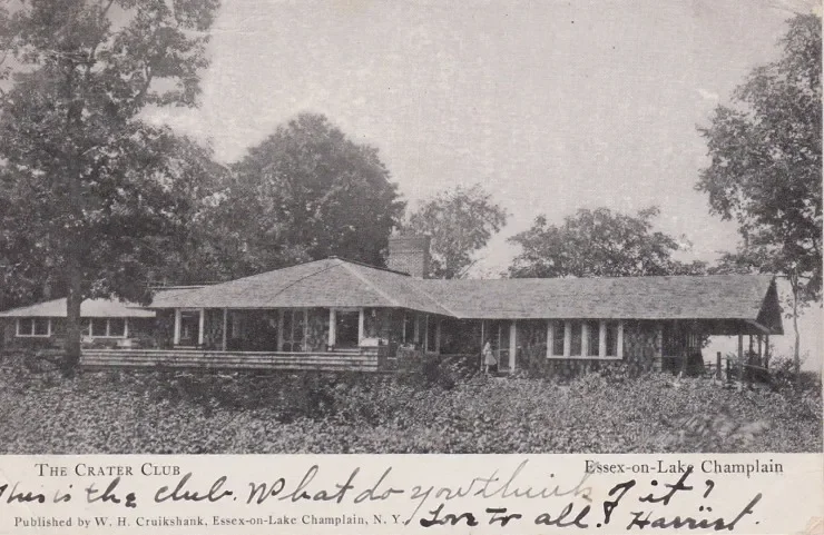Black and white photo of a house with a porch, trees in the background, and a handwritten note at the bottom reading "The Crater Club. Have the club, what do you think?"