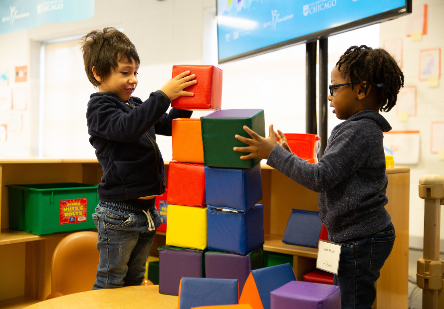 two boys playing with building blocks