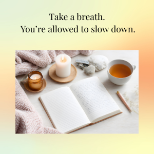 Open notebook surrounded by a candle, honey jar, stones, tea cup, blanket, and pencil, with the text 'Take a breath. You're allowed to slow down.' at the top.