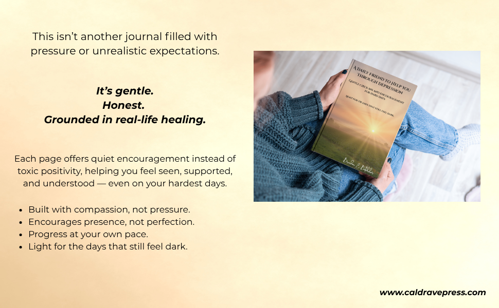 A person in a blue sweater sitting on the floor, holding a book with an image of a sunrise over a field on the cover.