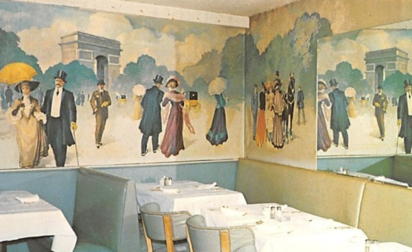 A mural painting of people walking outdoors in early 20th century attire, with the Arc de Triomphe in the background, inside a restaurant with tables set for dining.