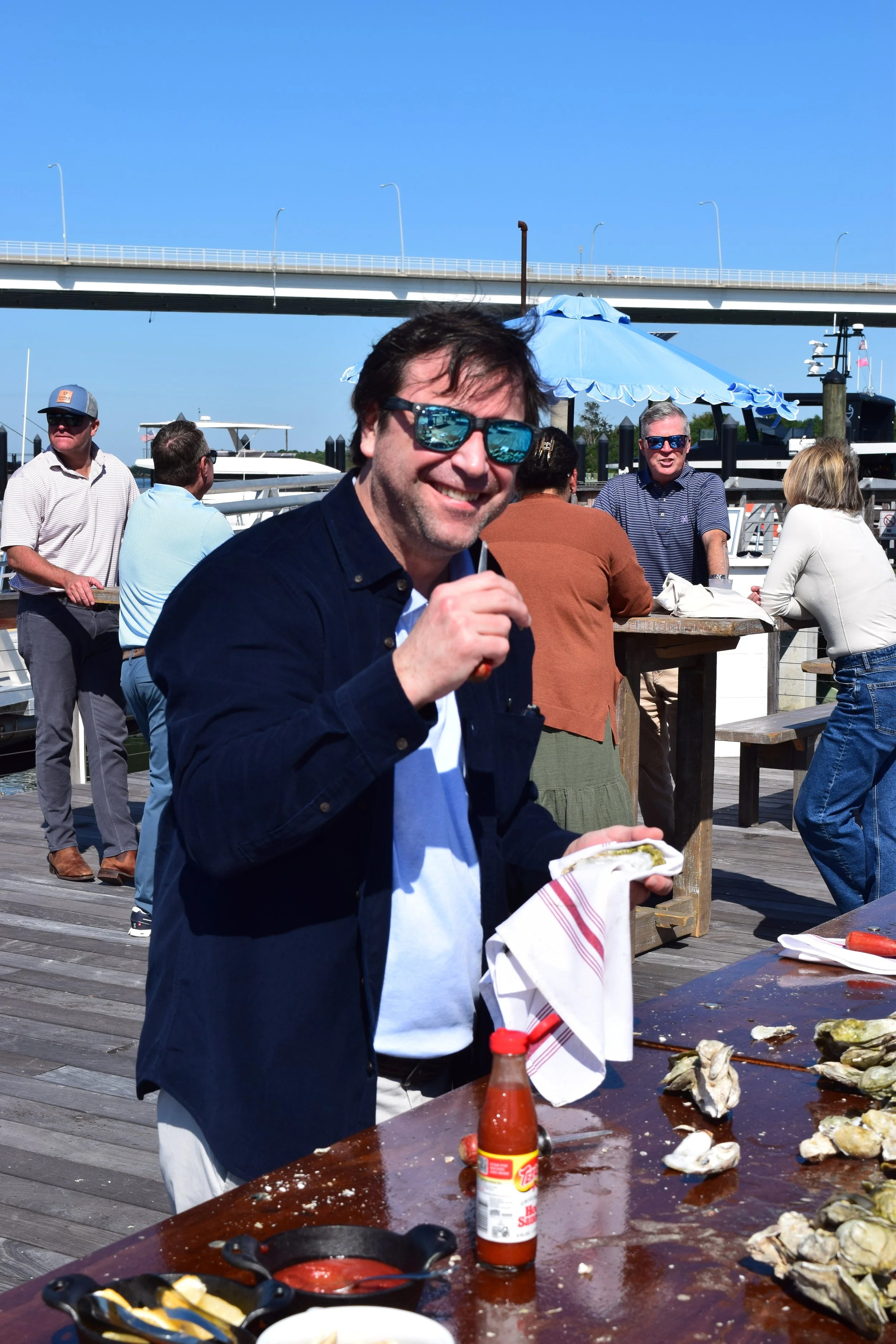 Enjoying shucking oysters with coworkers to unwind on the water 
