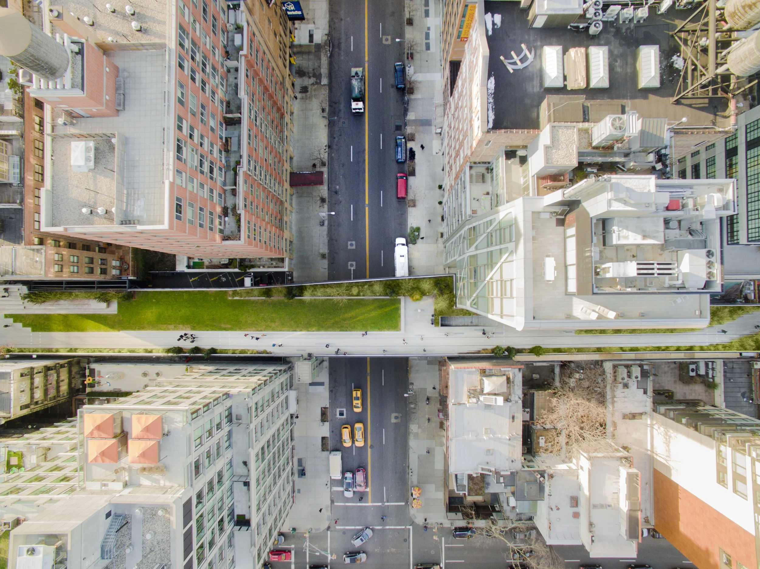 Aerial view of a city with a green walkway