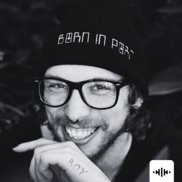 A smiling man wearing glasses and a black beanie that says "BOAN IN PEAR".