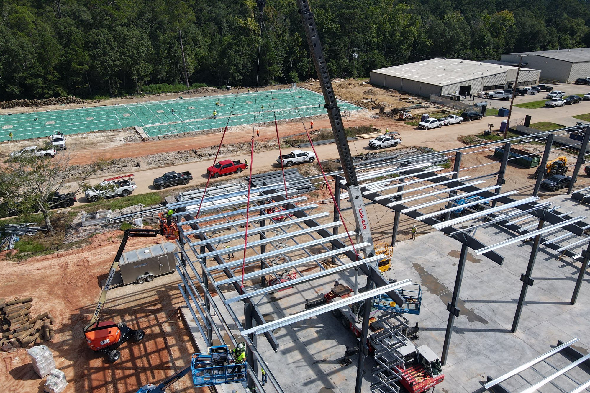 A crane sets a preassembled steel module into place at the Laborde Products jobsite during construction.