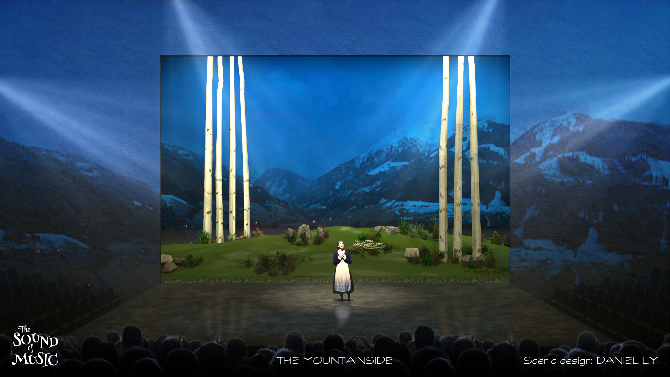 THE SOUND OF MUSIC SET DESIGN. Stage scene with a woman in traditional dress in front of a backdrop of mountains, trees, and a blue sky, with stage lighting and an audience in the foreground.