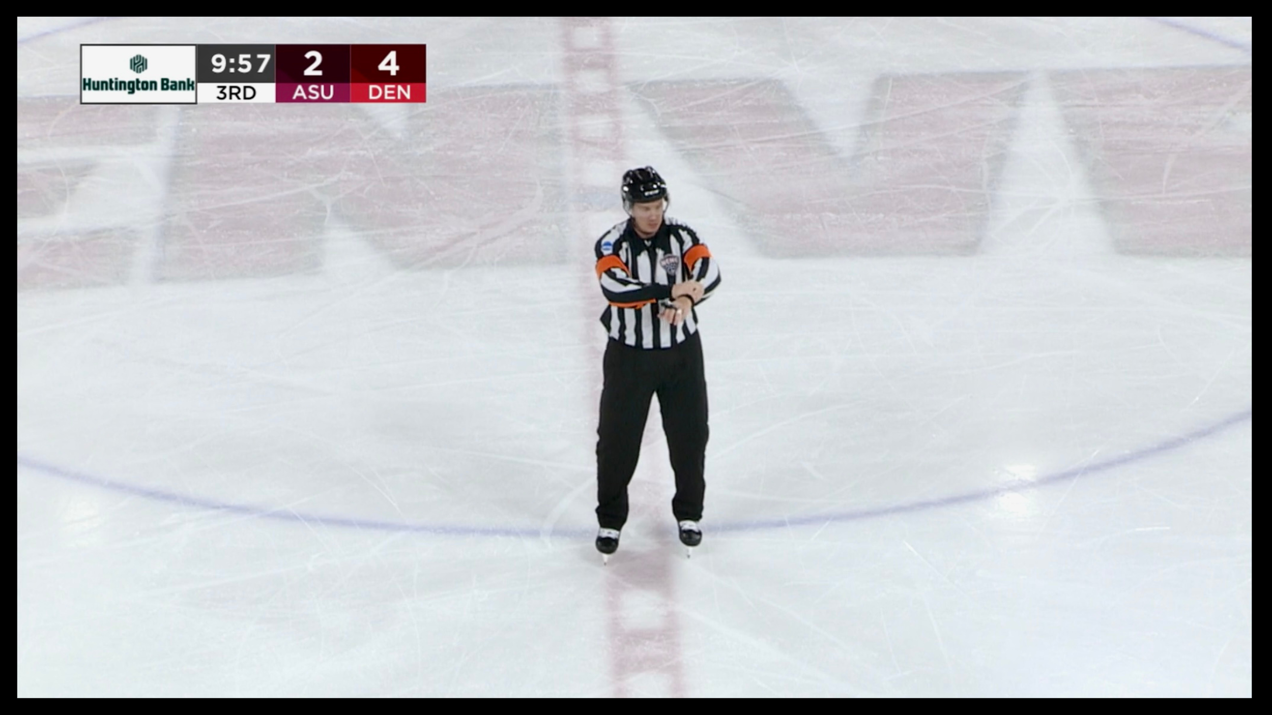 Michael Sheehan officiating a hockey game as a Division I referee, representing accountability, leadership, and fair play