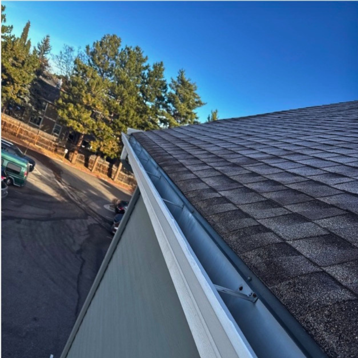 Roofline and gutter system on multi-family HOA property in Denver Colorado showing proper drainage and maintenance condition