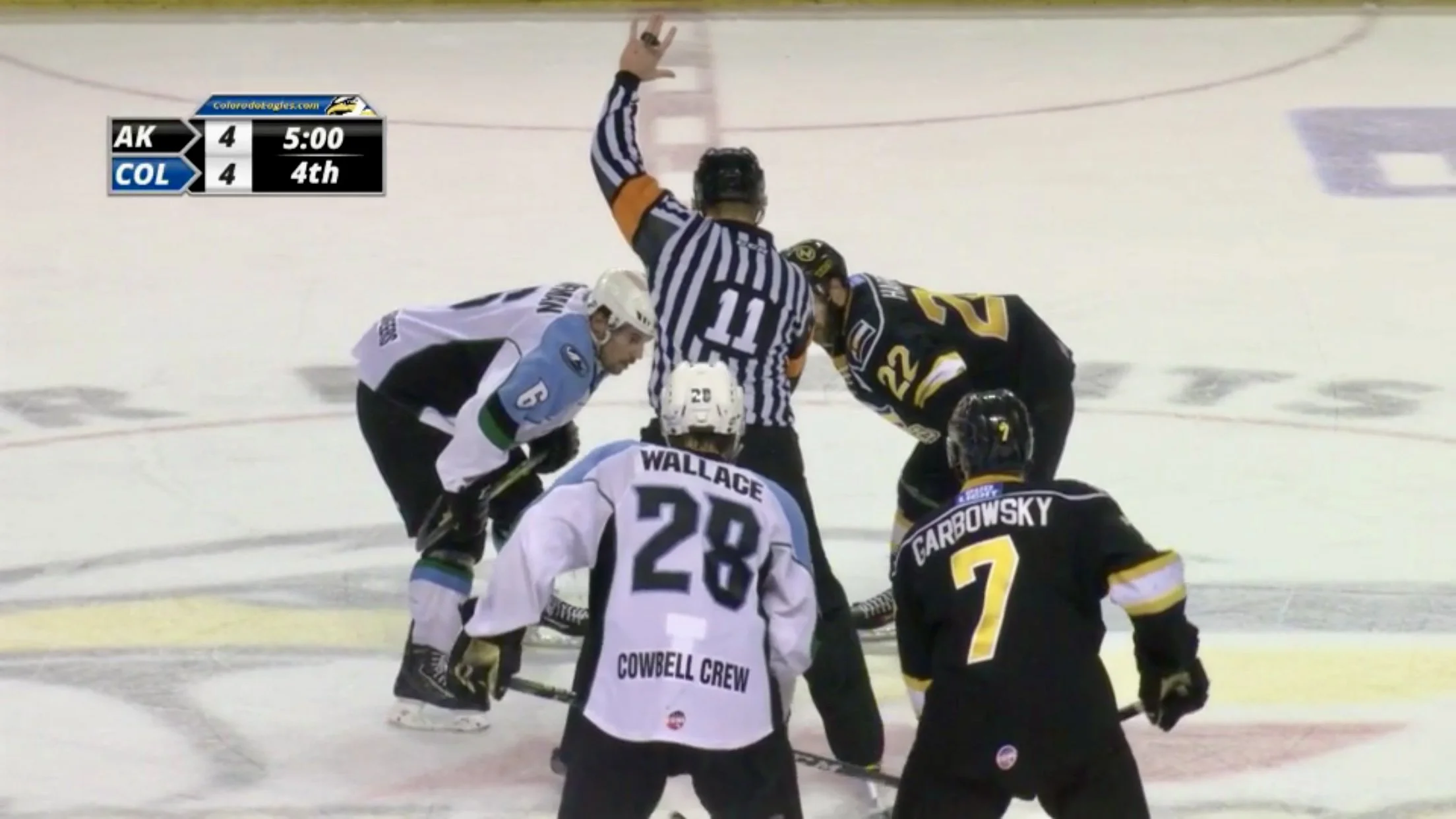 Michael Sheehan officiating a hockey game as a Division I referee, representing accountability, leadership, and fair play