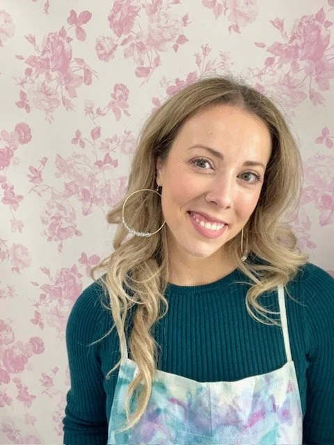 Caitlin (Cali T Creative) is a bold, joyful, and unapologetically colorful artist whose work celebrates playfulness, confidence, and human connection. Her artwork spans multiple mediums: wire-wrapped jewelry, acrylic giraffe paintings, graphic design