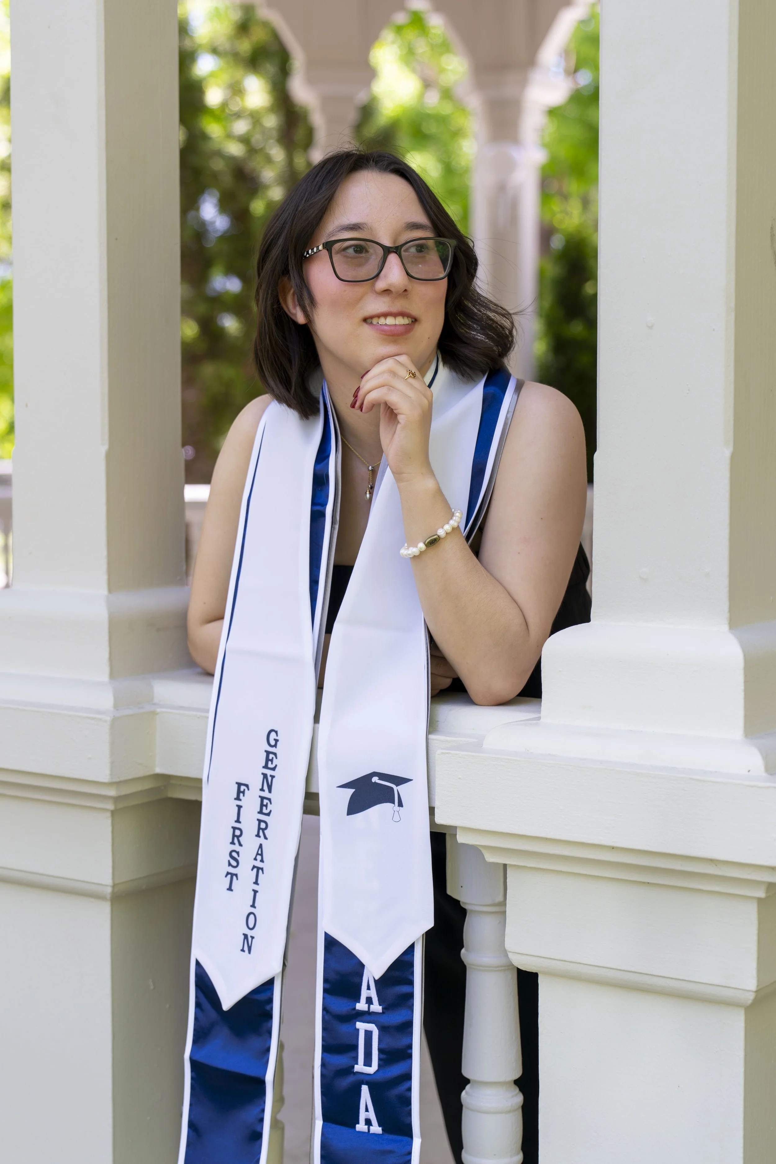 A young woman poses for a graduation photo.