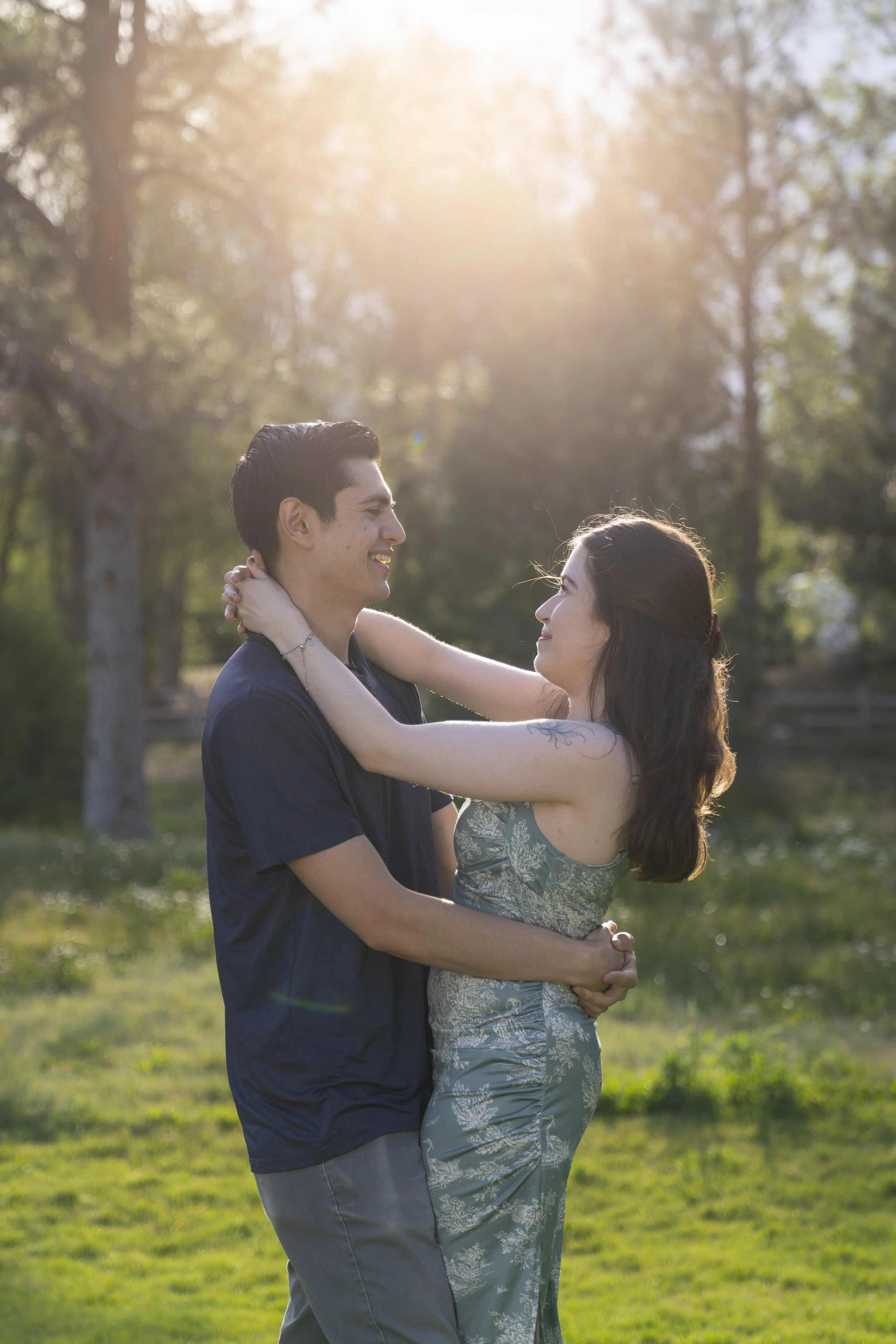 A young couple embraces each other for an engagement photoshoot.