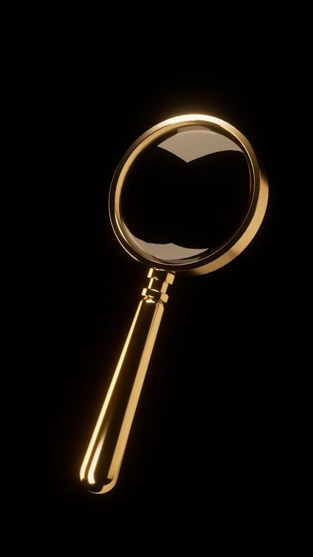A gold-colored magnifying glass against a black background.