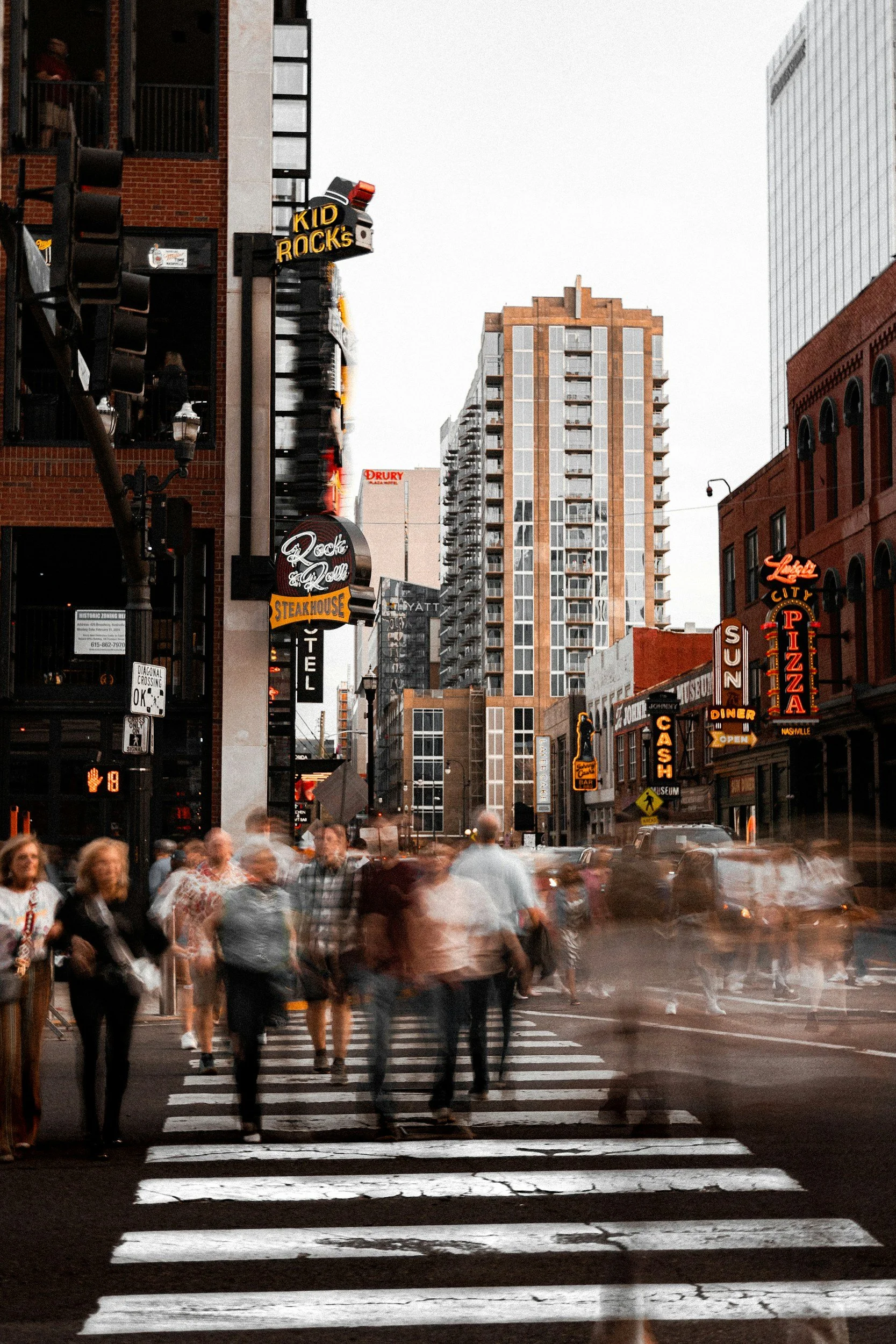 Blurred pedestrians walking through downtown Nashville, Tennessee.