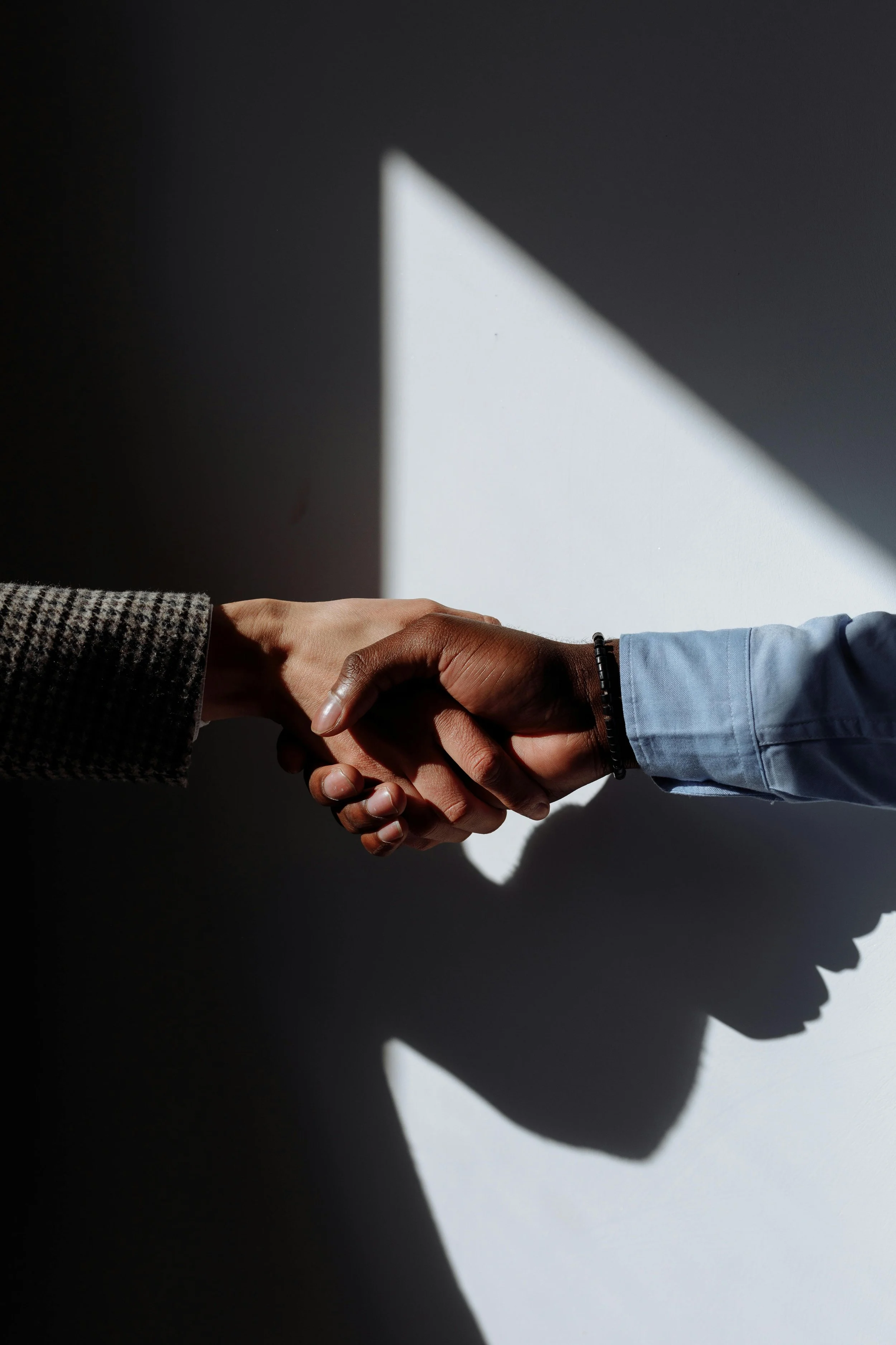Recruiter and hiring manager shaking hands during an executive search meeting in Dallas-Fort Worth