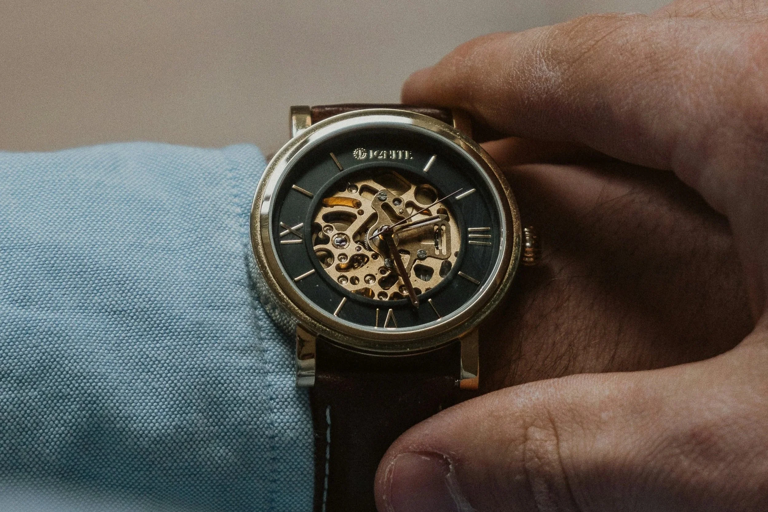 Close-up of a professional adjusting a wristwatch, symbolizing the extended time it takes to fill CPA-required accounting roles