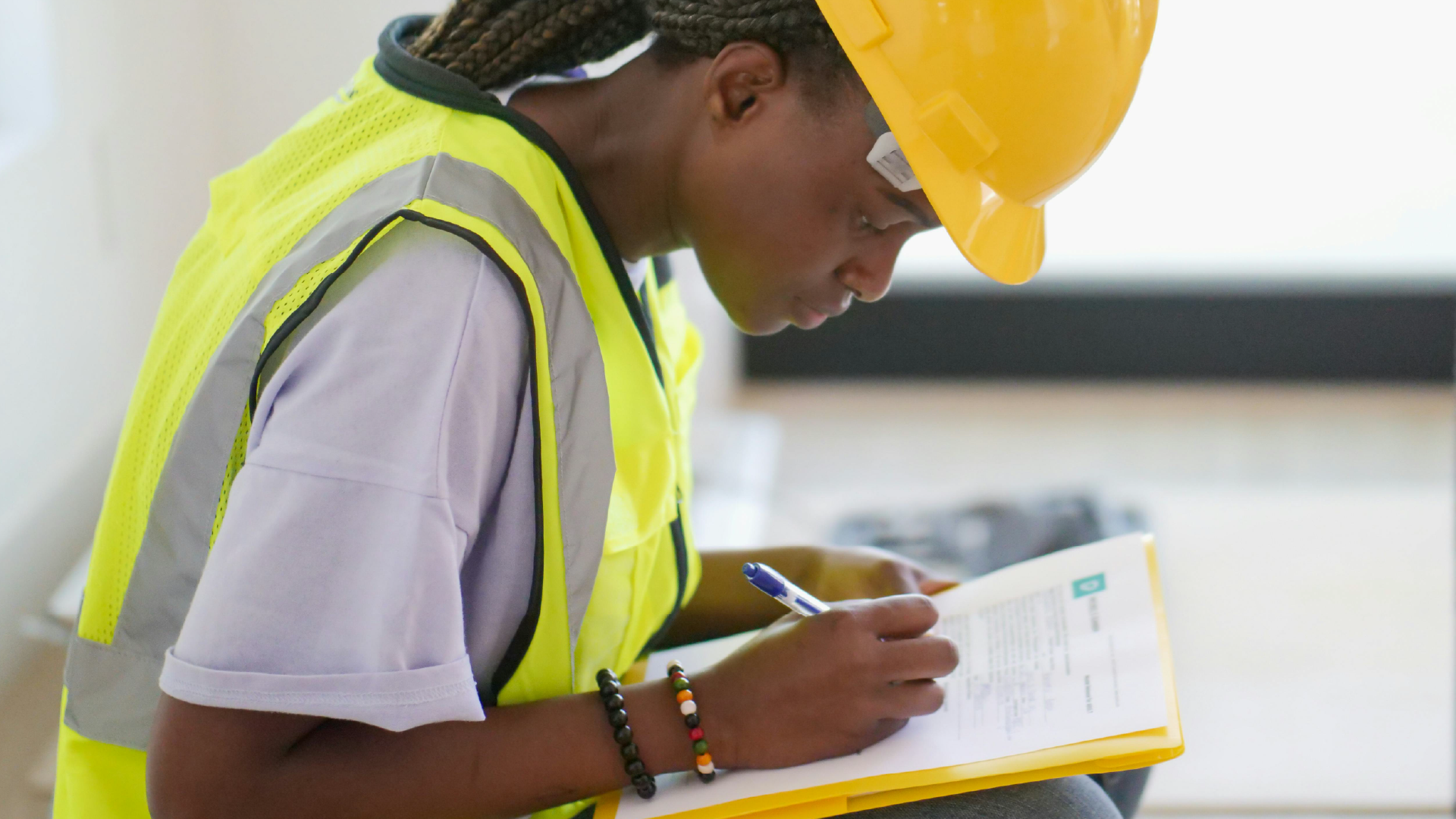 A young construction worker on a project site, representing the next generation of talent and the ongoing need for skill development and industry growth.