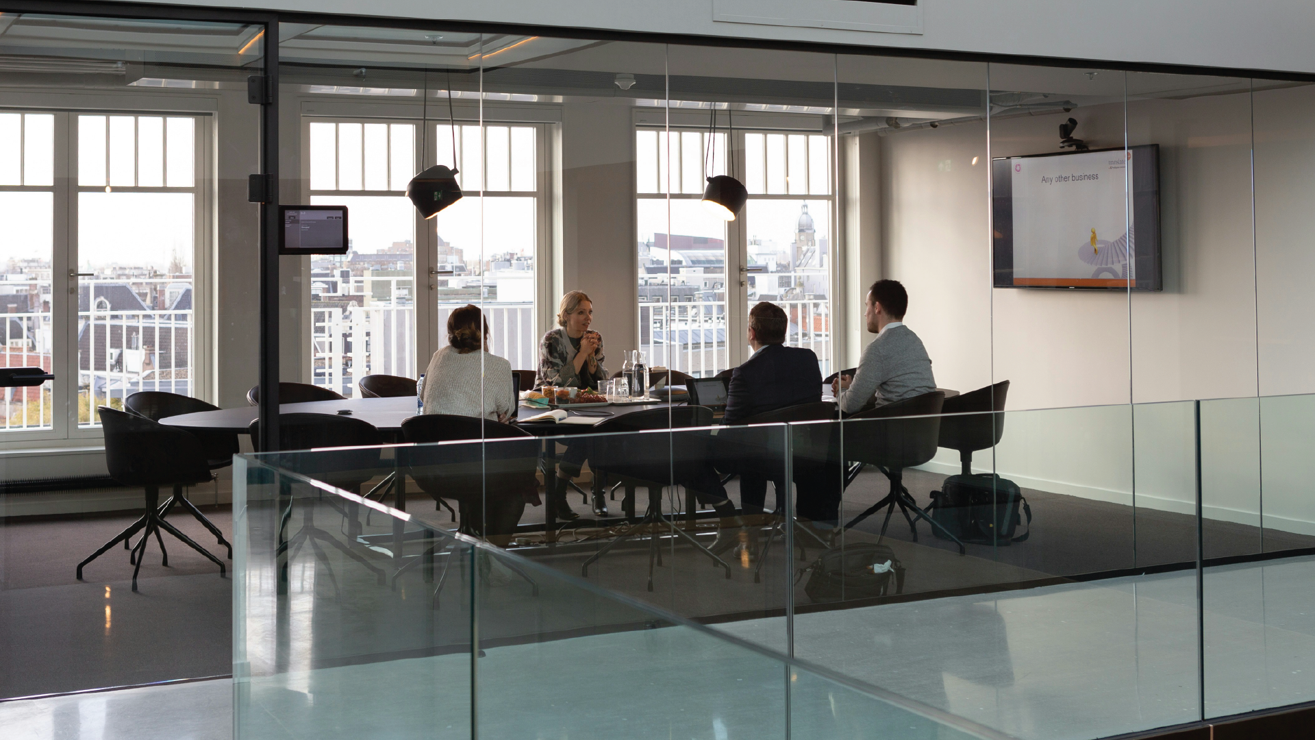 A group of professionals in a modern conference room discussing high-level talent trends and organizational maturity for the 2026 hiring market.