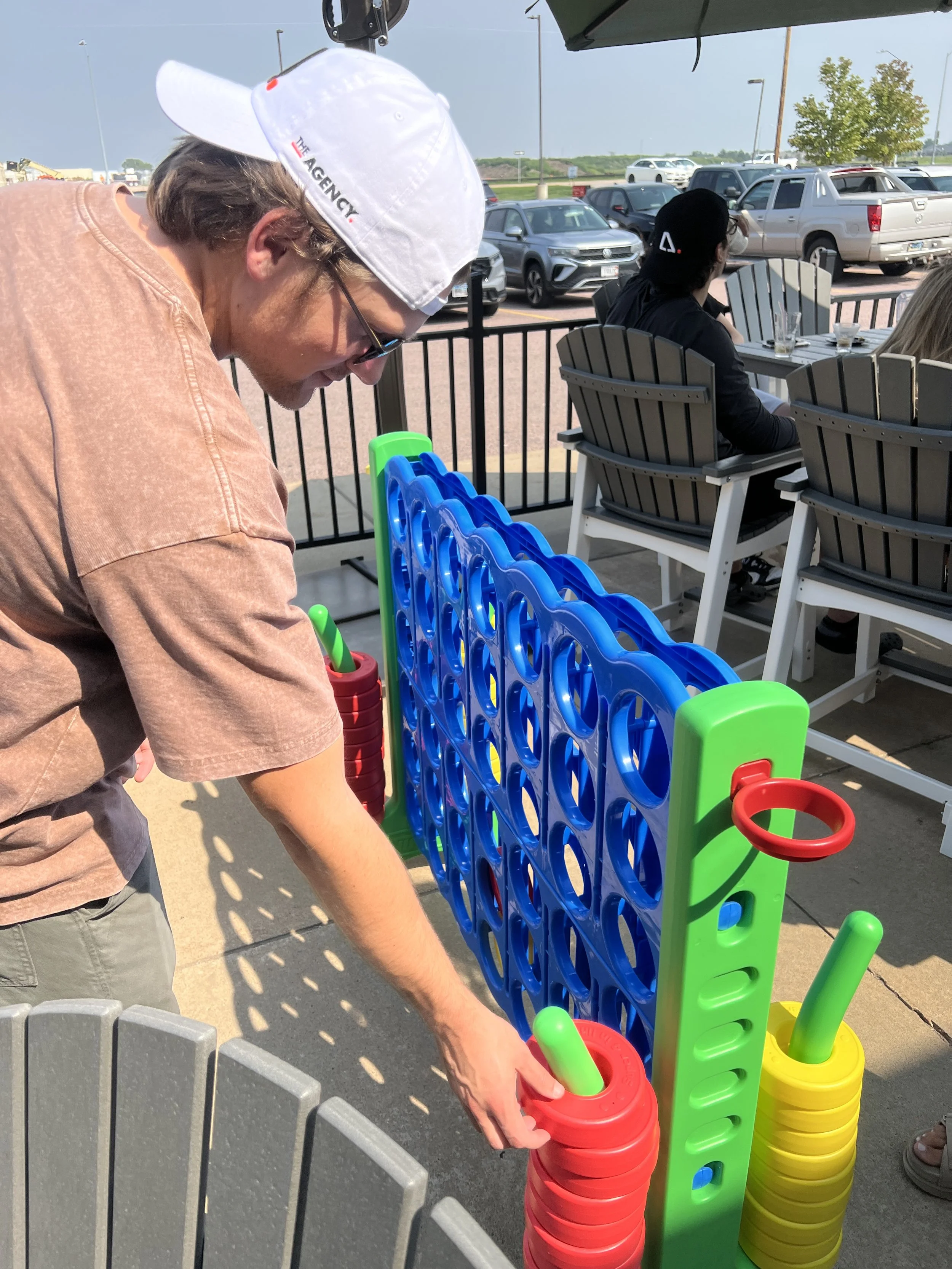 An employee playing yard games on a patio
