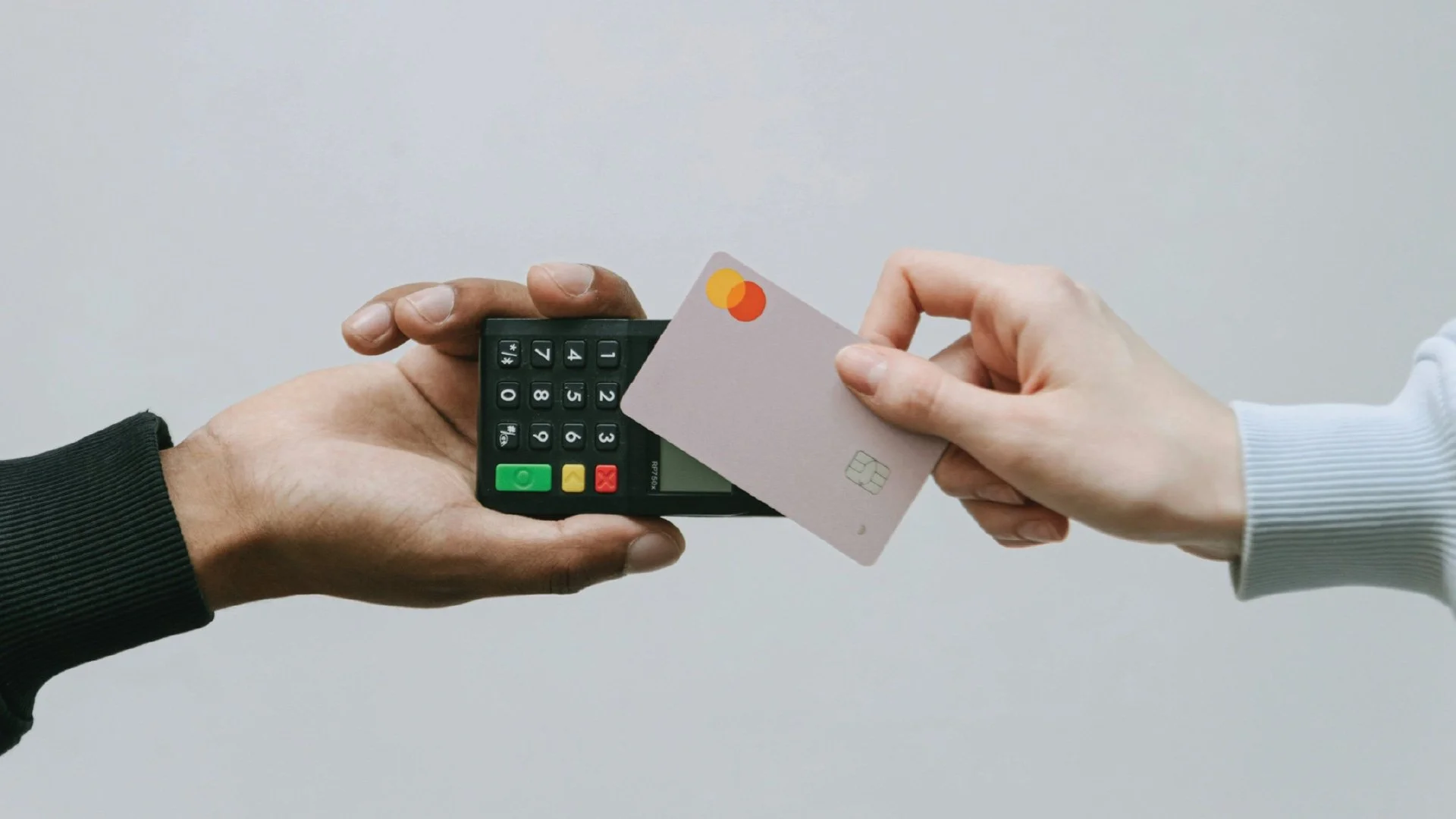 A close-up of a contactless tap-to-pay transaction, symbolizing the seamless and invisible integration of financial services into daily life.