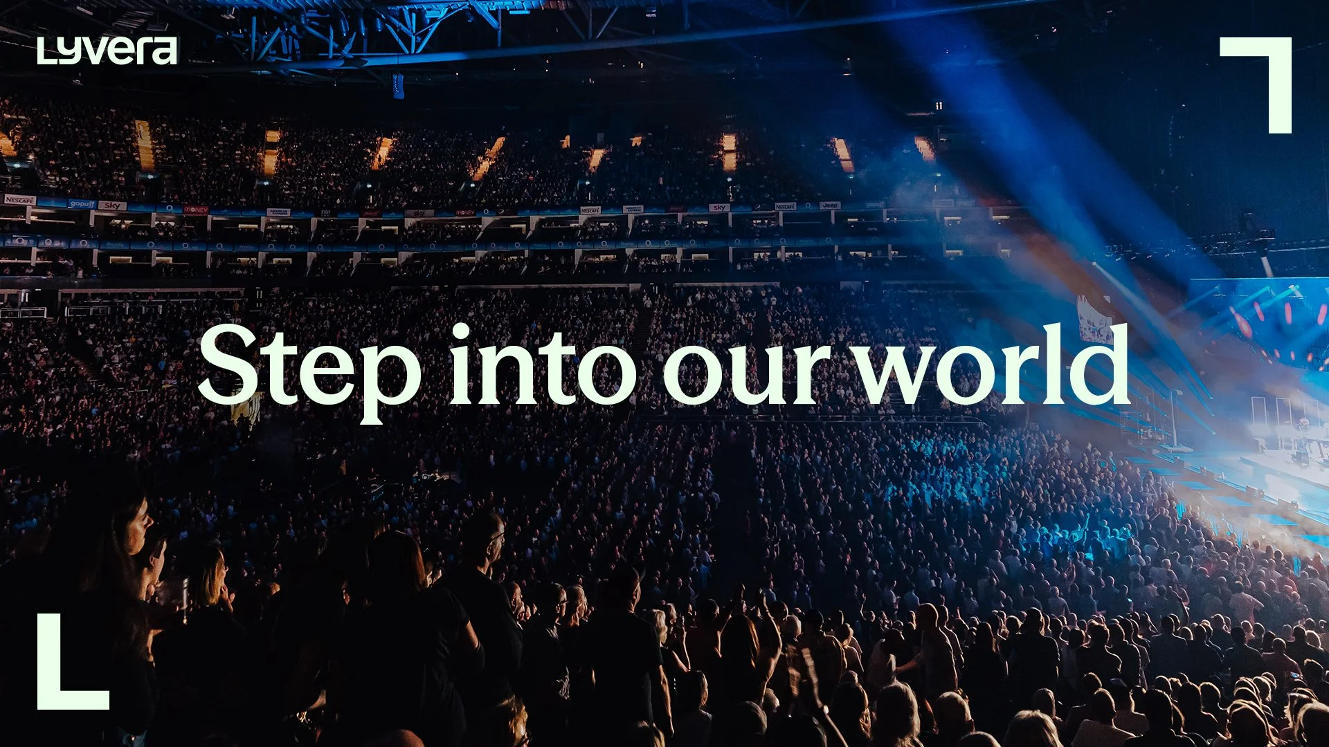 A large indoor concert or event with a full audience, stage, and lighting effects, featuring the text "Step into our world" overlaid on the image, this is the Lyvera launch campaign asset.