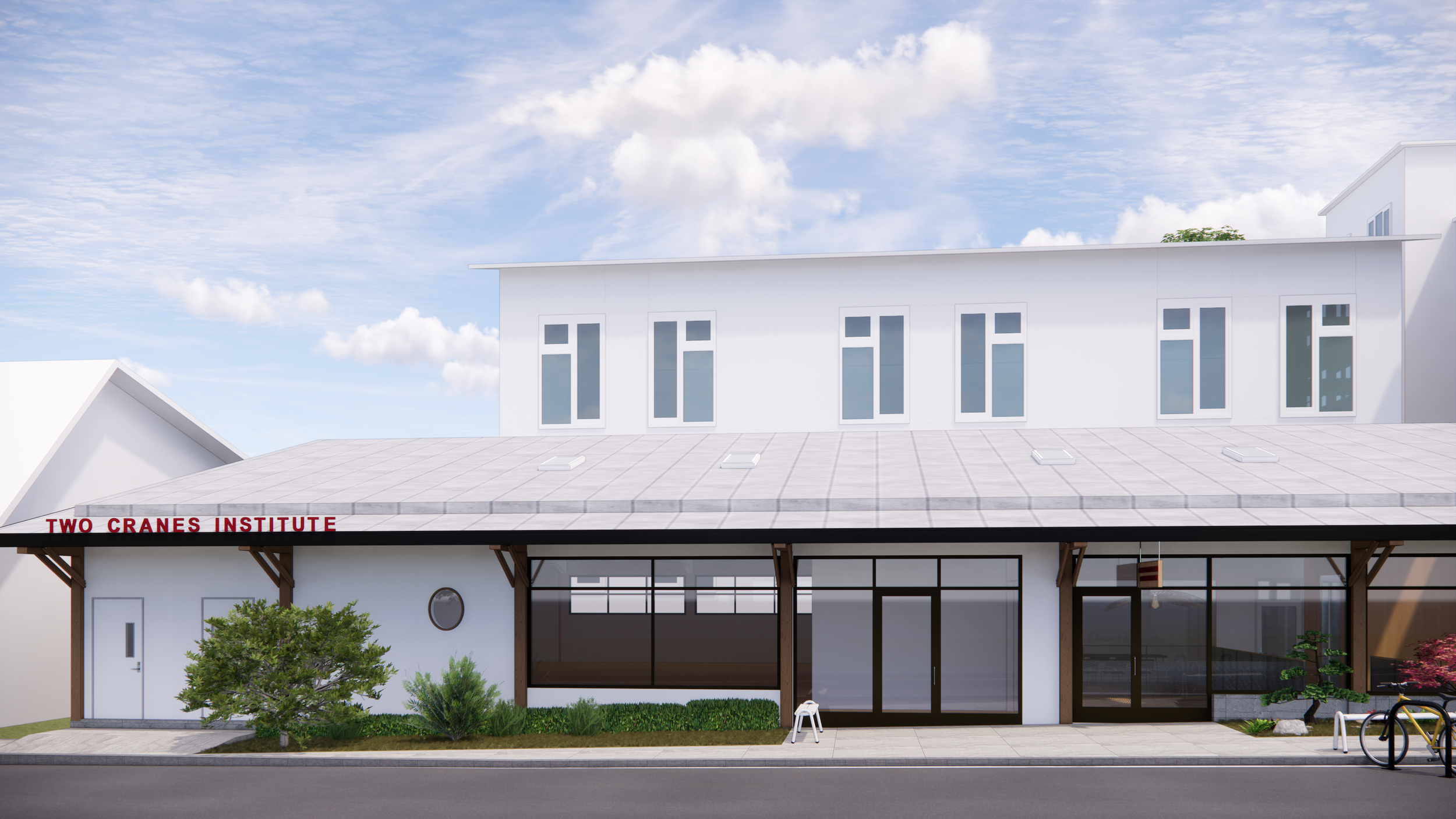 Front view of a modern, white two-story building with a sign that reads 'Two Cranes Institute' above the entrance, featuring large glass windows, landscaped greenery, and a clear blue sky with clouds.