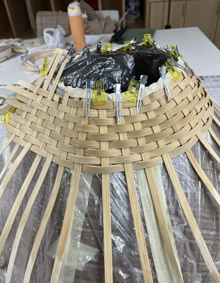 Hand weaving the skirt
