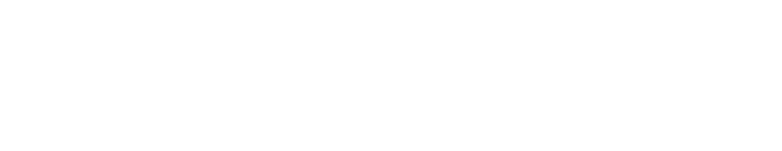 A black Labrador Retriever sitting on a grassy surface with a blue frisbee in its mouth