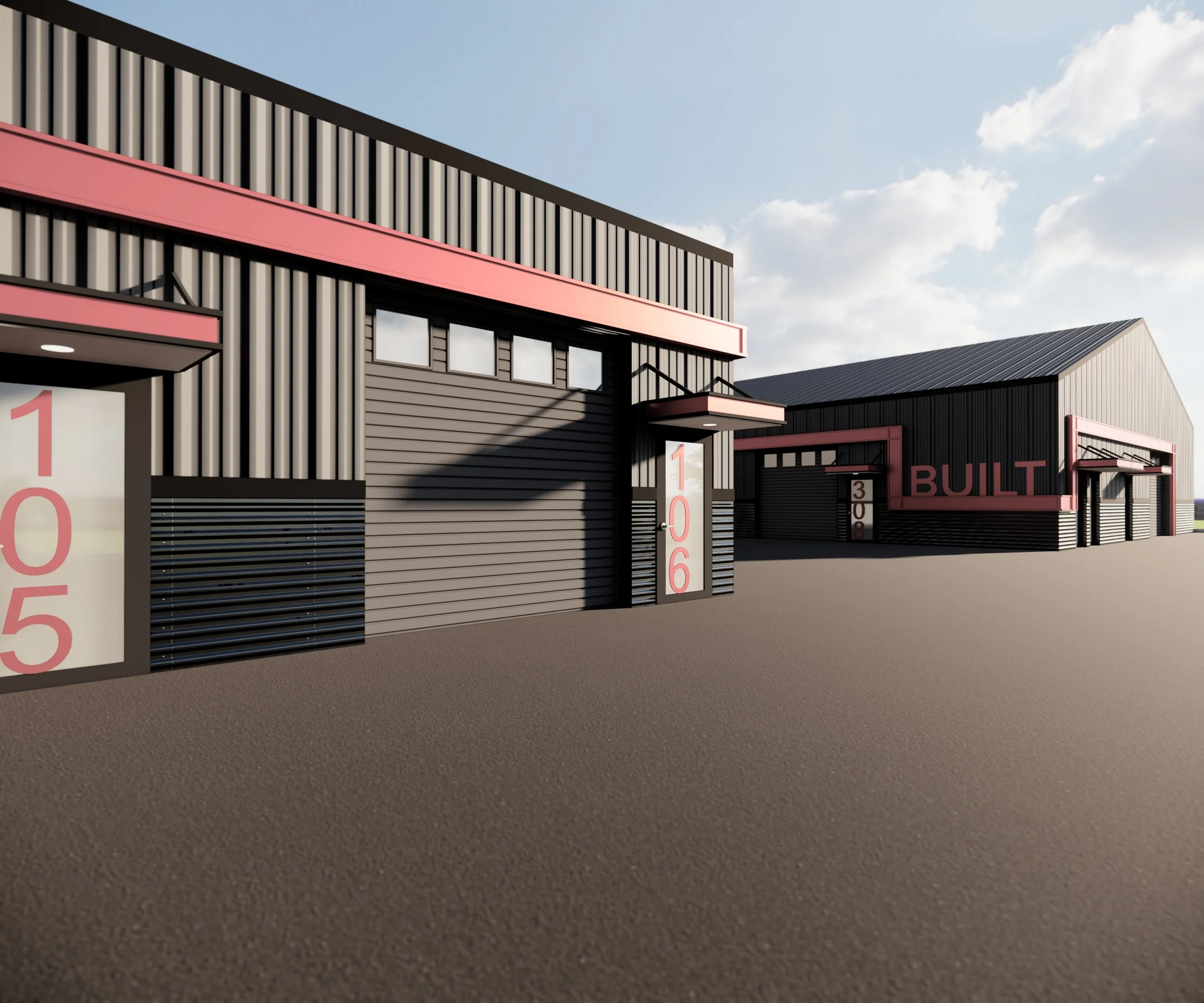An industrial-style building with black metal siding and pink accents, including large pink numbers and the word 'BUILT', with a clear sky and some clouds in the background.