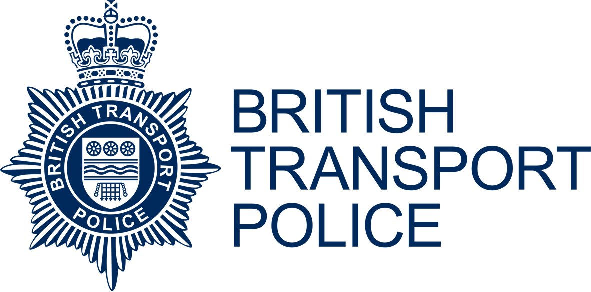 The logo of the British Transport Police, featuring a crown at the top, a star-shaped badge with the words 'British Transport Police,' and a circular emblem with a shield showing waves and wheels, all in dark blue.
