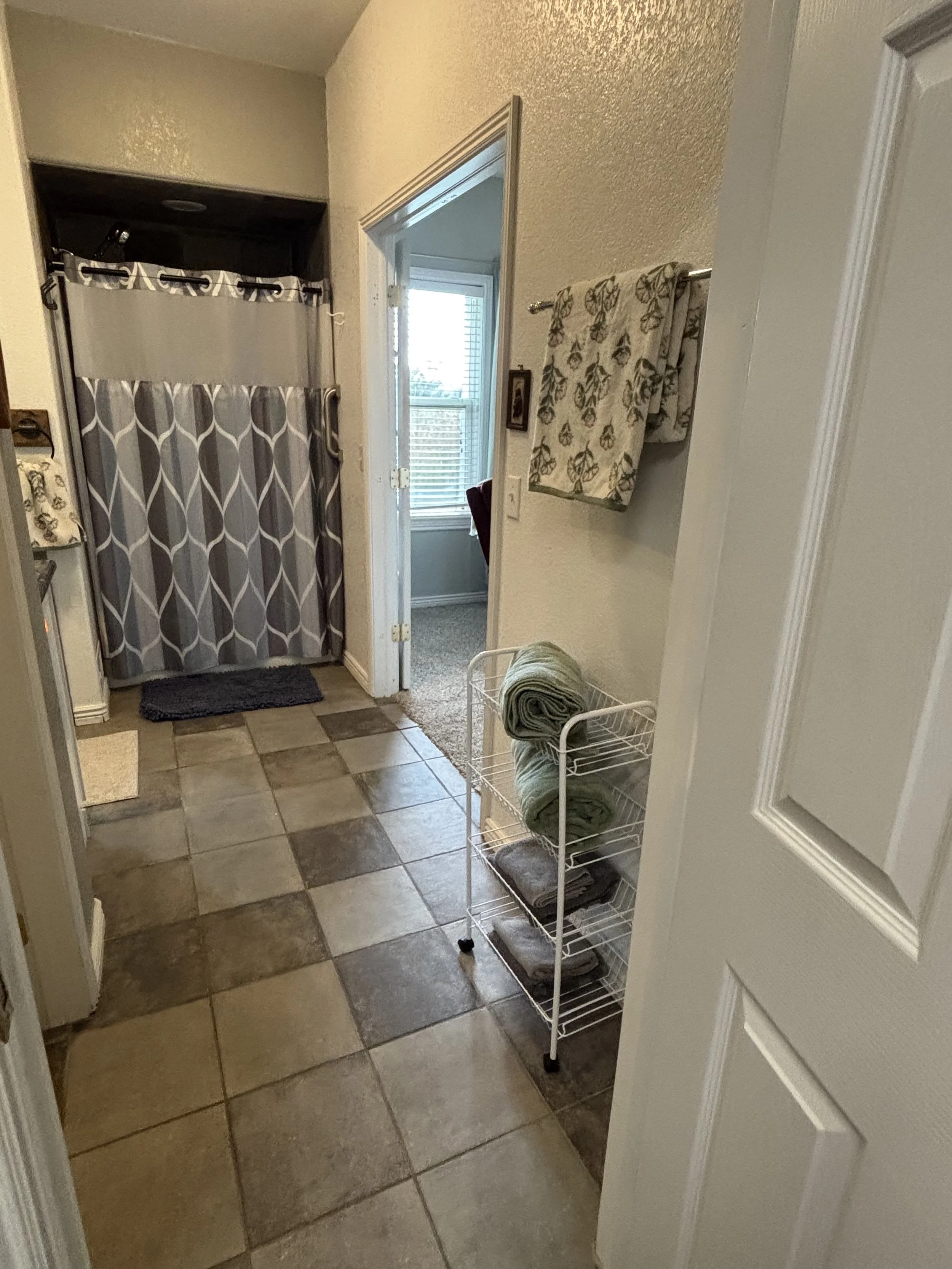 Master bathroom with double sinks, shower, and bath