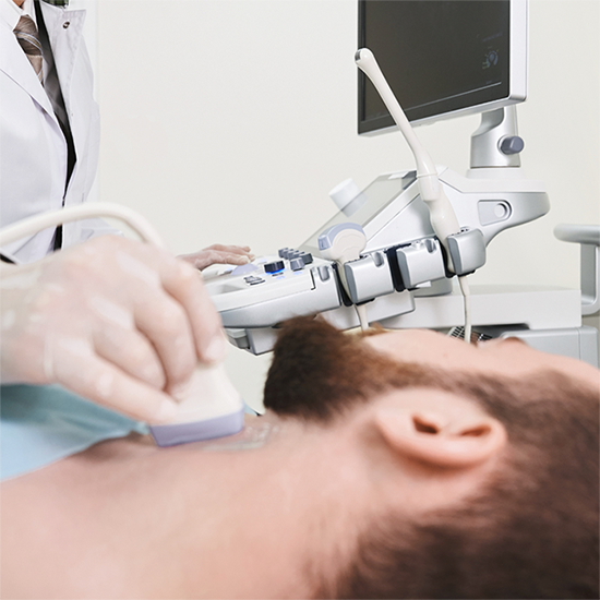 Doctor performing an ultrasound on a patient's neck in a medical office.
