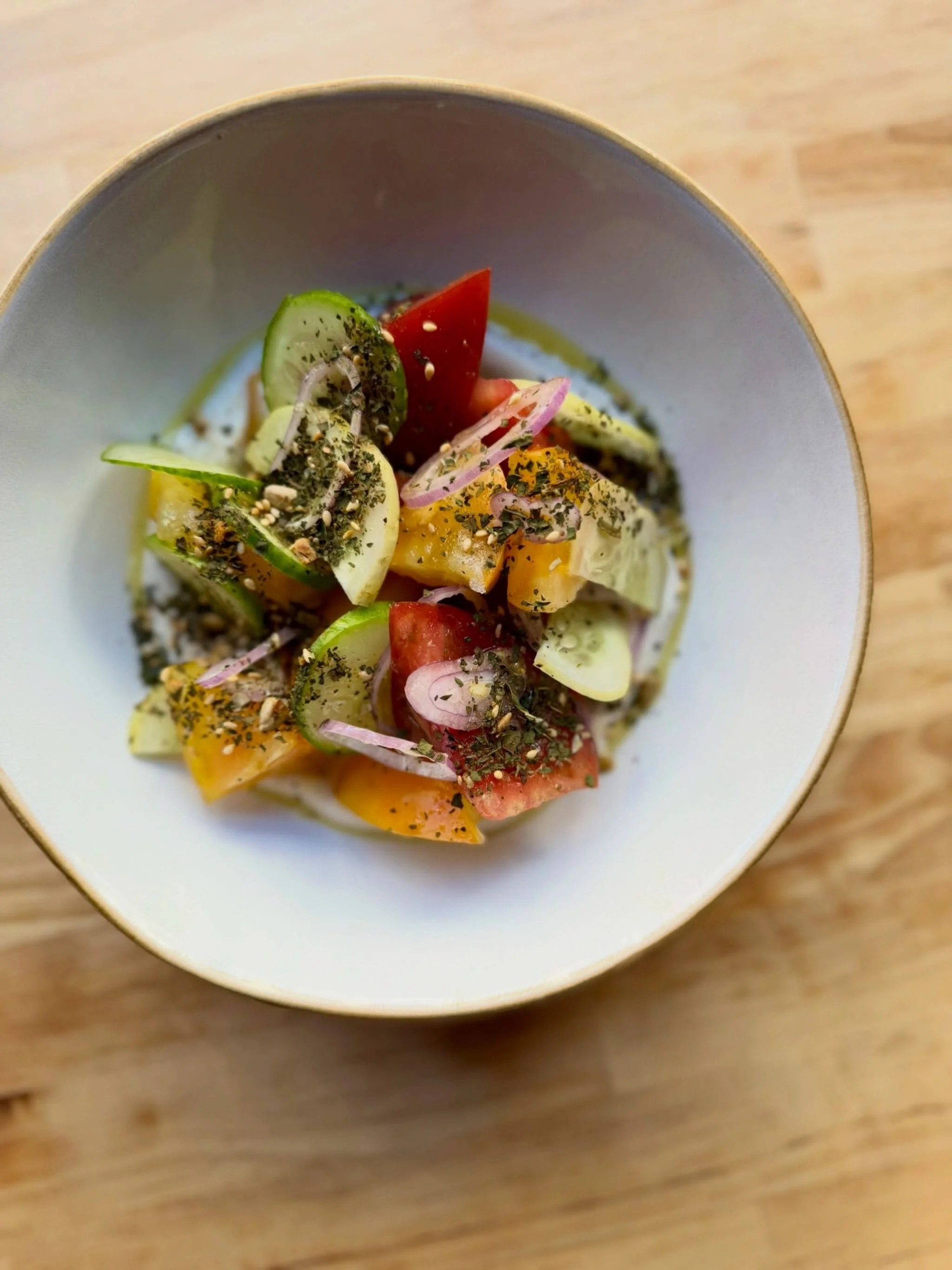 Leaving summer and entering fall with bounty from @deartablefarm 🍅 Heirloom Tomato Salad &mdash; cucumber, shallot, tahini, toasted kale seasoning

On the menu in Queen Anne! 

#tomatoseason #washingtonfarms #seattlerestaurants #queenanneseattle