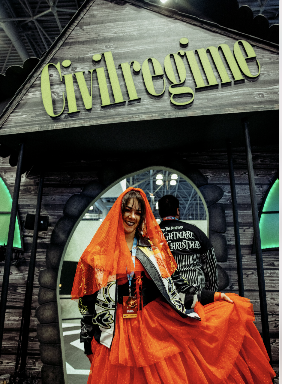 A woman dressed up at New York Comic Con 2024 in front of the Civil Regime booth activation. Event production and marketing by Laura Alyse Rubin along with Civil Regime.
