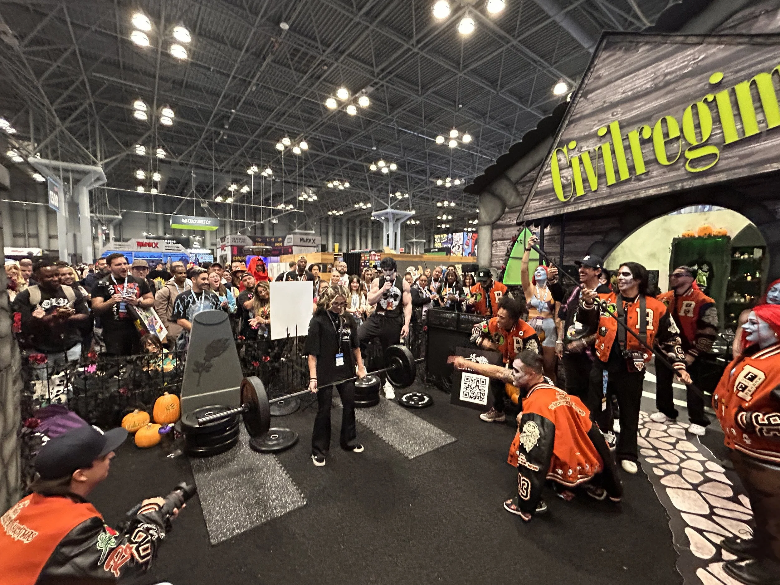 New York Comic Con 2024 Nightmare Before Christmas event activation for the clothing brand Civil Regime. Event production and marketing by Laura Alyse Rubin. People gathering for a weightlifting competition with costumes.