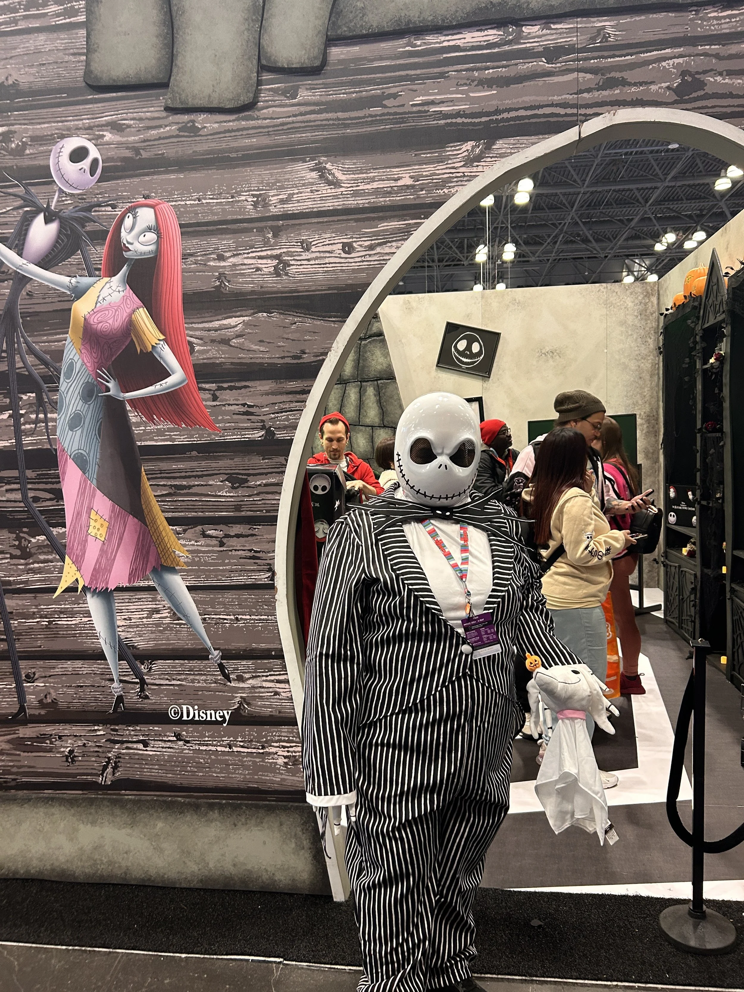 A person dressed as Jack Skellington from The Nightmare Before Christmas posing at a Disney Tim Burton New York Comic Con 2024 booth. Event production and marketing by Laura Alyse Rubin.