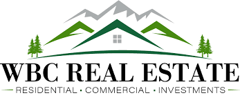 Logo for WBC Real Estate featuring stylized mountains, a house roof, and trees with text indicating the company specializes in residential, commercial, and investment properties.