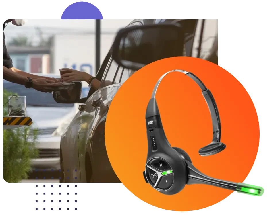 A person is handing a cup of coffee to another person through the window of a car, with a pair of wireless headset headphones with a microphone in the foreground.