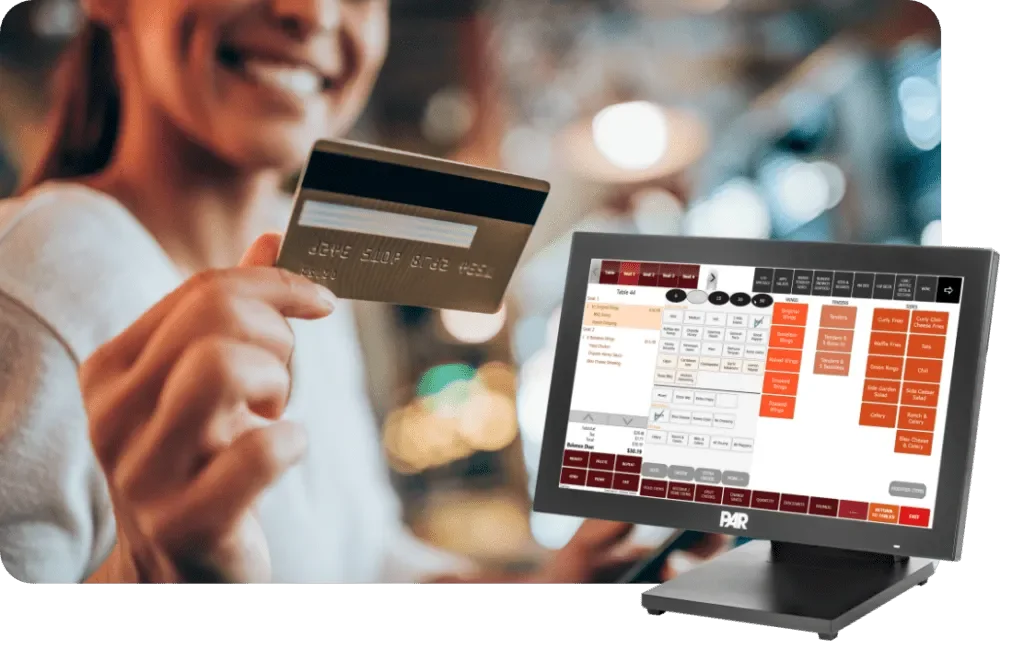 A person holding a credit card in front of a digital point-of-sale system with a restaurant seating chart displayed.