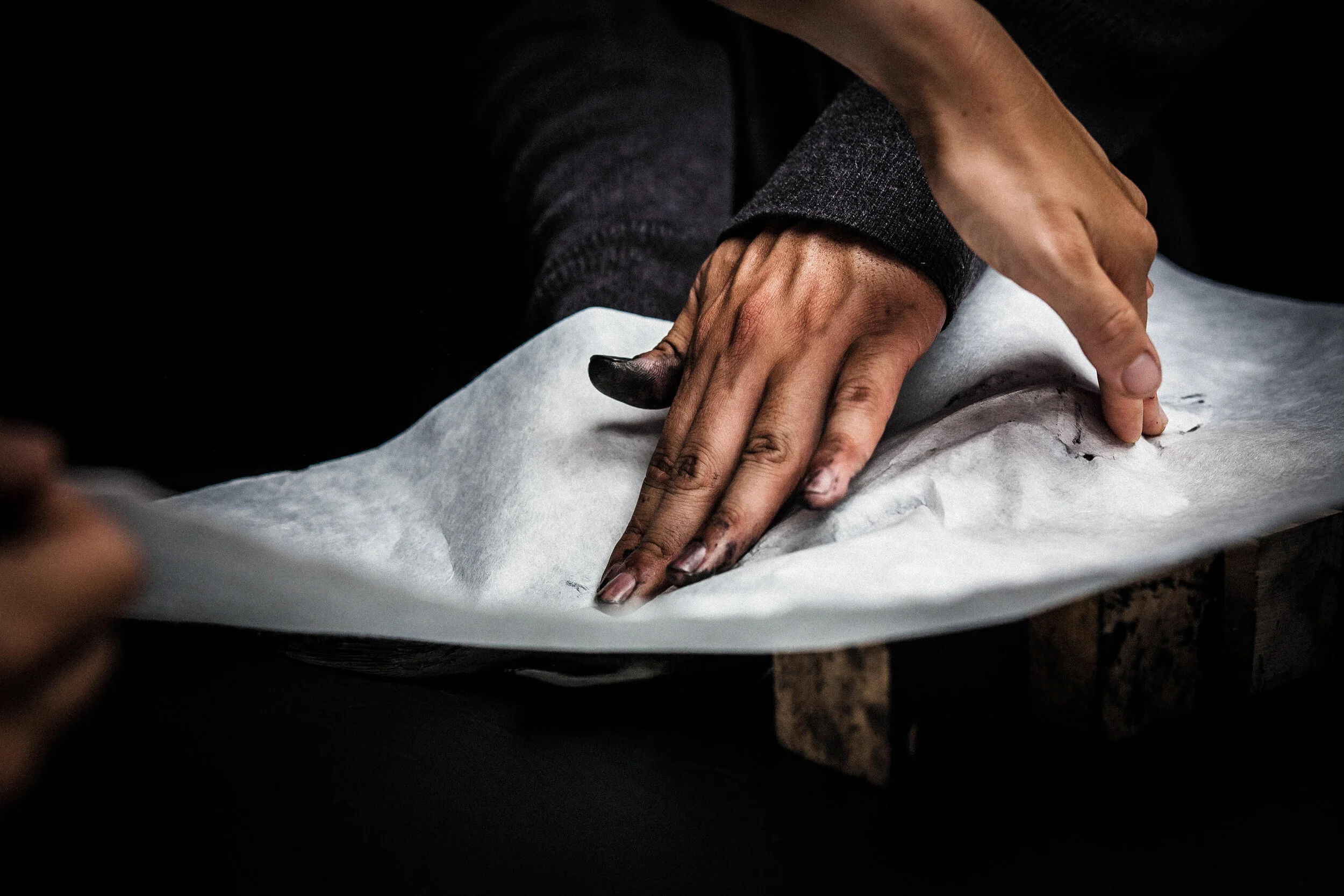 Here, with the help of his wife, Dwight presses rice paper over the ink covered fish.