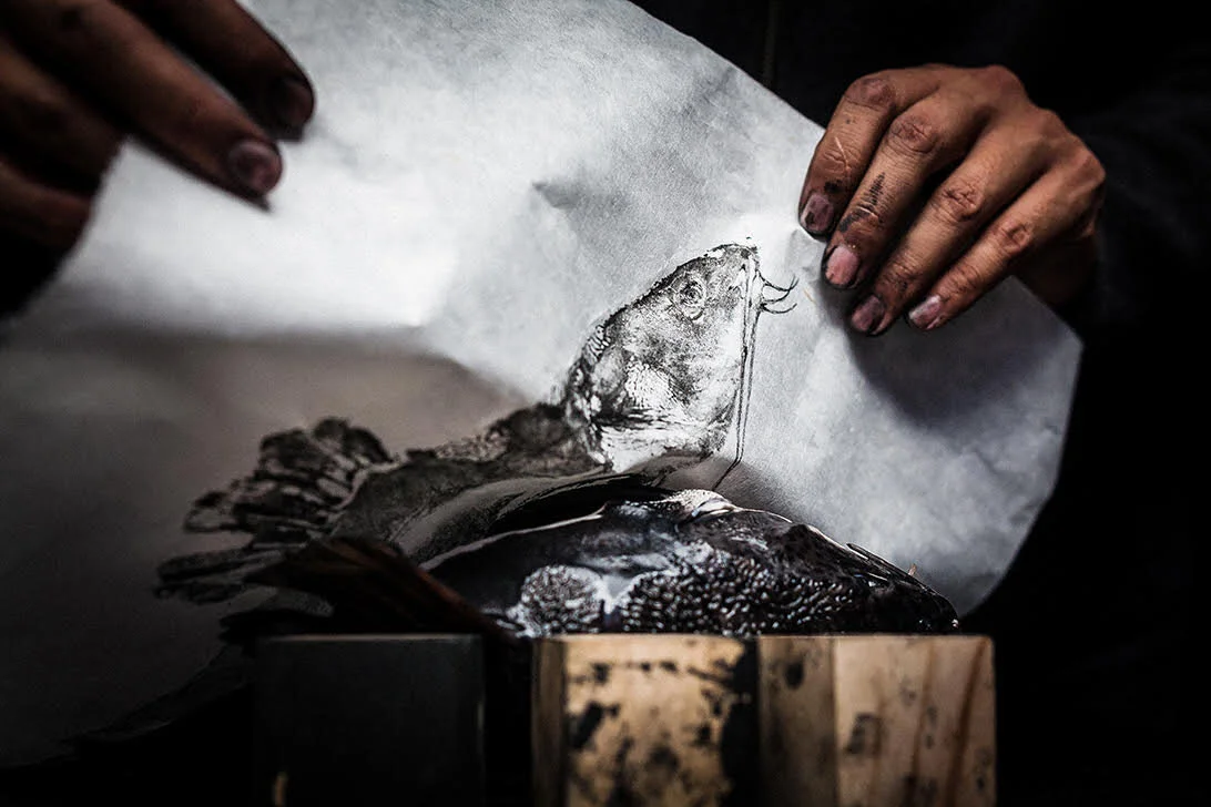 After assuring the paper has been pressed on the desired areas, Dwight lifts the paper away to reveal his print.