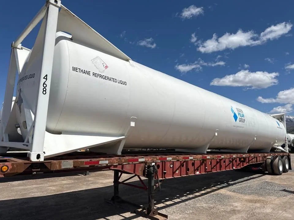 A large white cylindrical tanker trailer on a flatbed truck, labeled 'Methane Refrigerated Liquid' and with a logo for Copper Pine Group, parked outdoors under a blue sky with clouds.