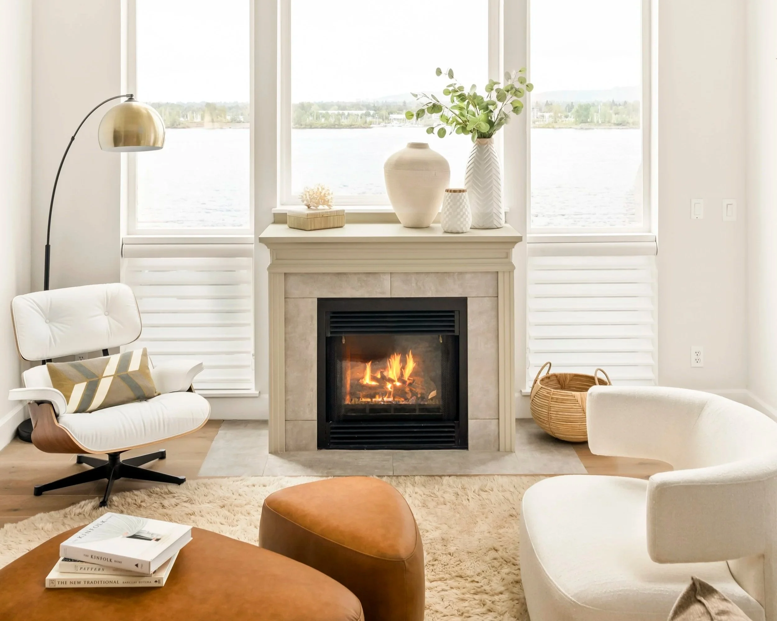 tranquil living room with fireplace in Vancouver WA overlooking Columbia river, white vases and basket