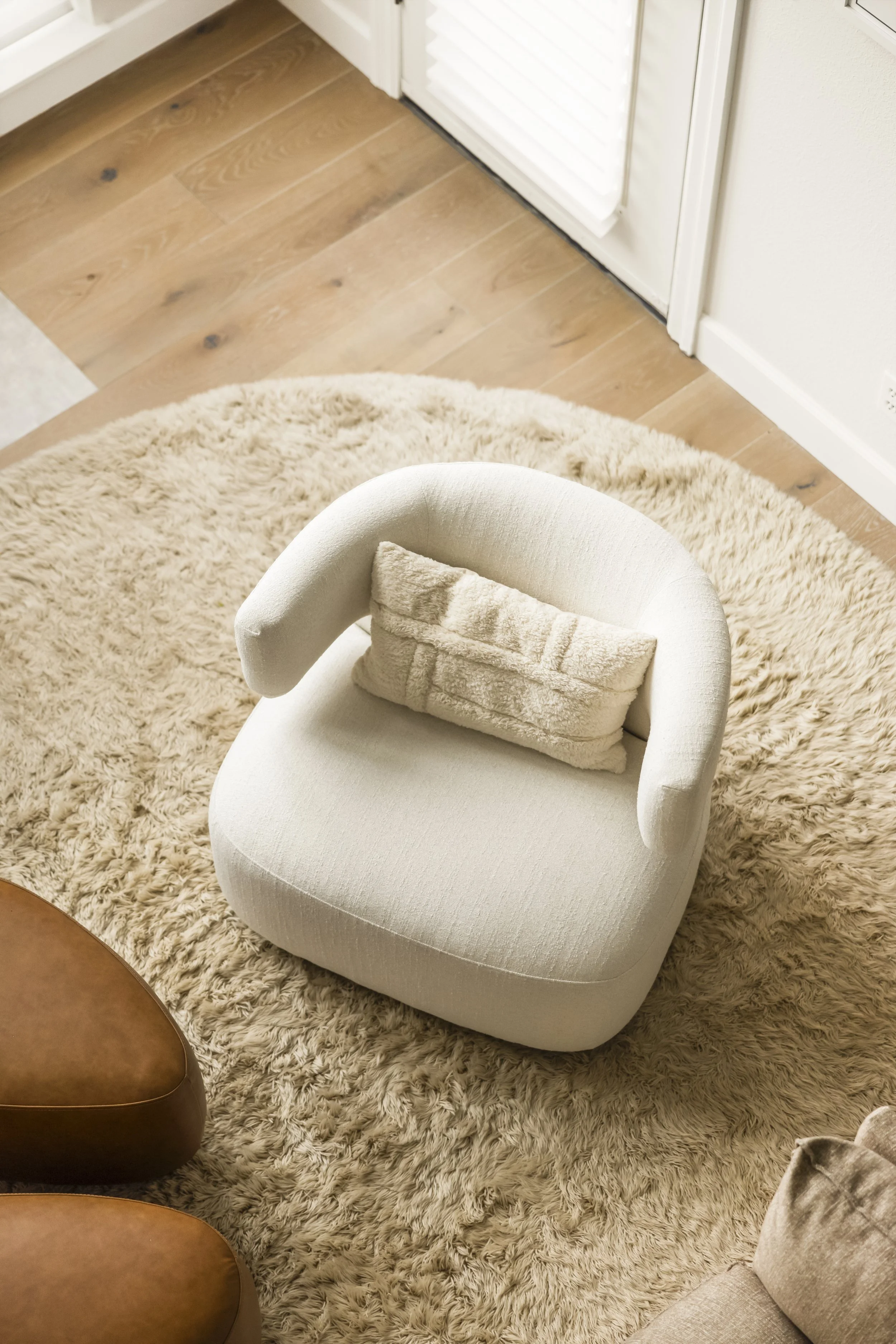 Aerial living room — round chair, rug vancouver-wa-condo-living-room-aerial-design-with-refinement.jpg