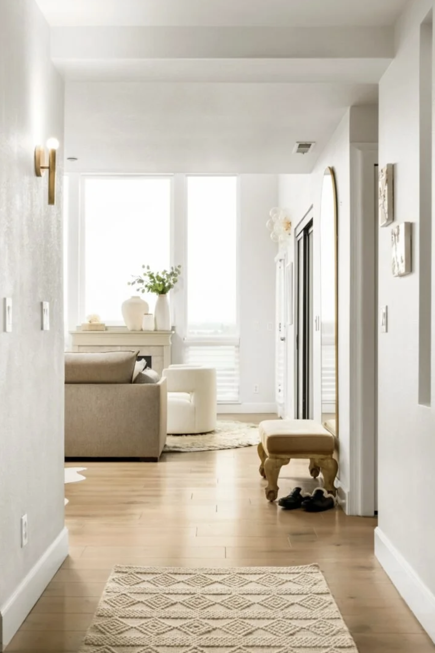 Entryway to a home with neutral furniture, rug and light filled space.  Portland interior design by Design With Refinement.