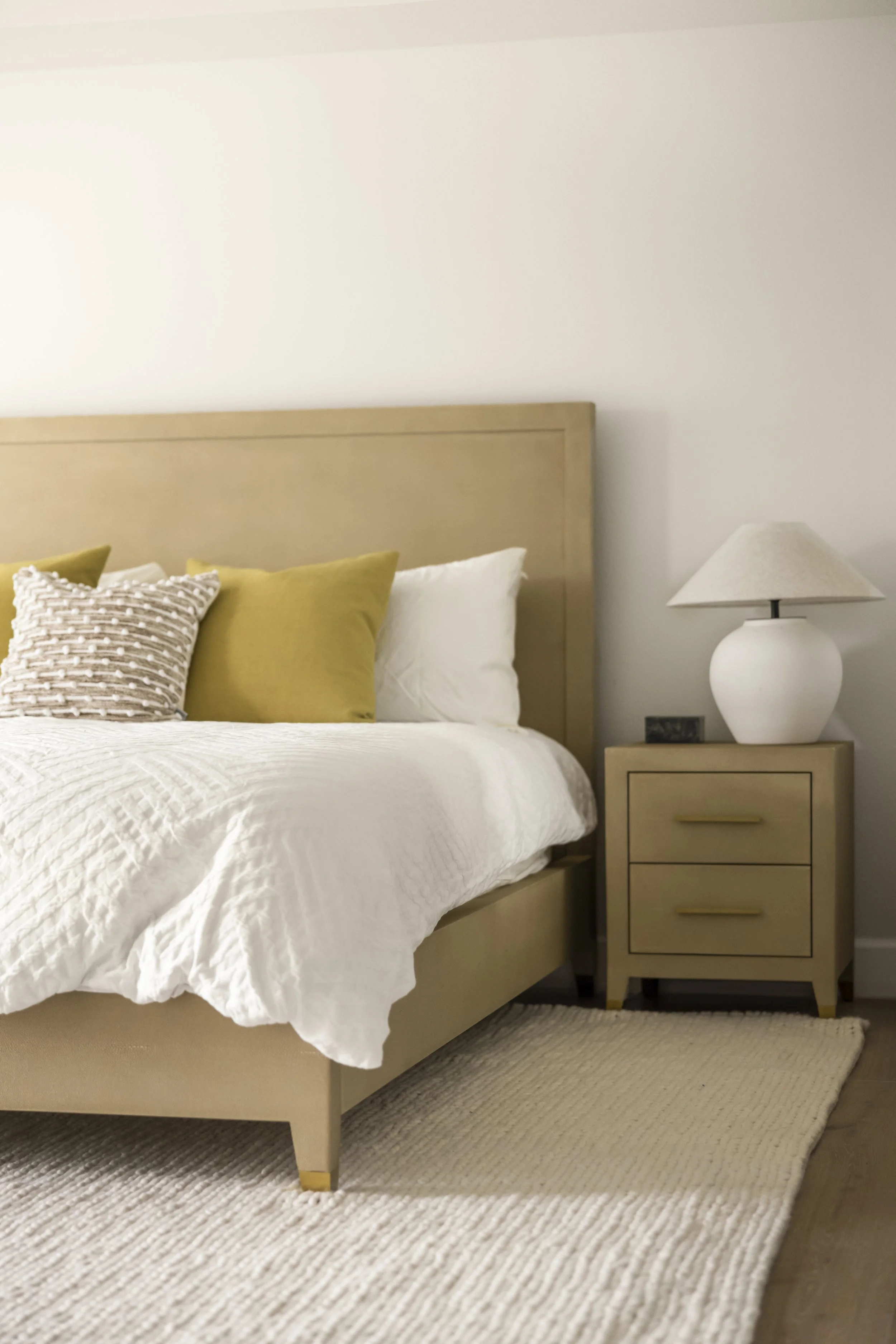 Primary bedroom with leather headboard and gold velvet pillows, Vancouver WA interior design by Design With Refinement