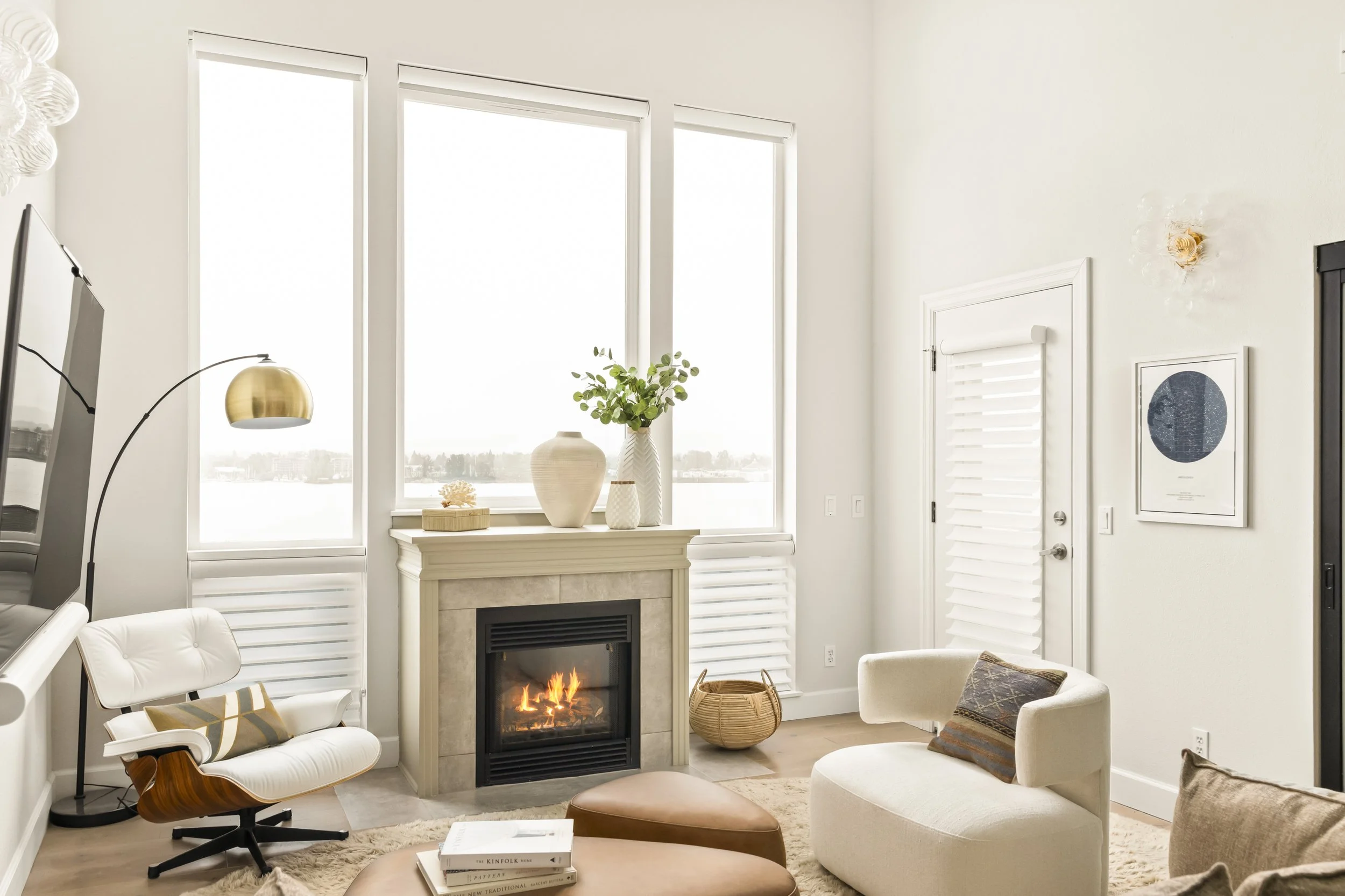 Warm modern living room with boucle accent chair and fireplace, Vancouver WA condo interior design