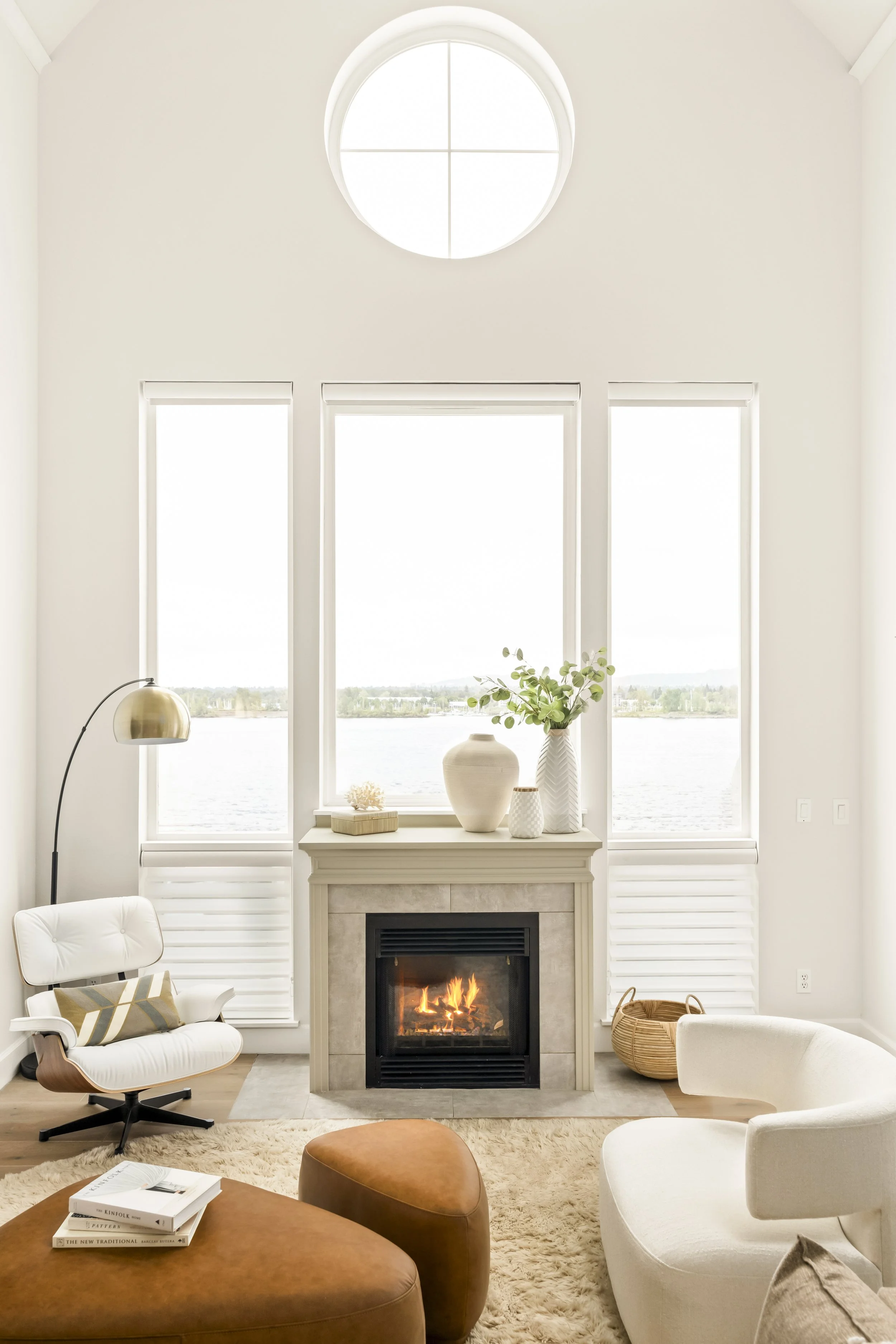 Light-filled living room with marble fireplace and waterfront views, Vancouver WA interior design by Design With Refinement